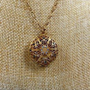 Catherine Popesco gold tone circular locket with iridescent rhinestone details
